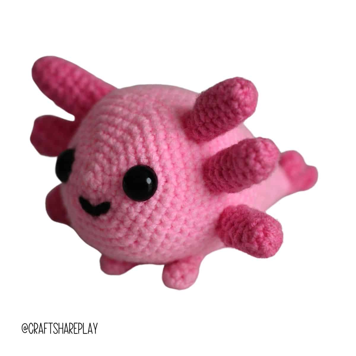 The side view of the handmade axolotl stuffie.