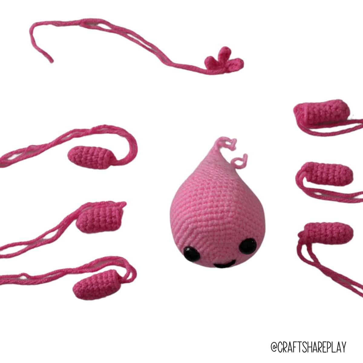 The crochet pieces of the axolotl amigurumi including the fins and the tail that need to be stitched together.