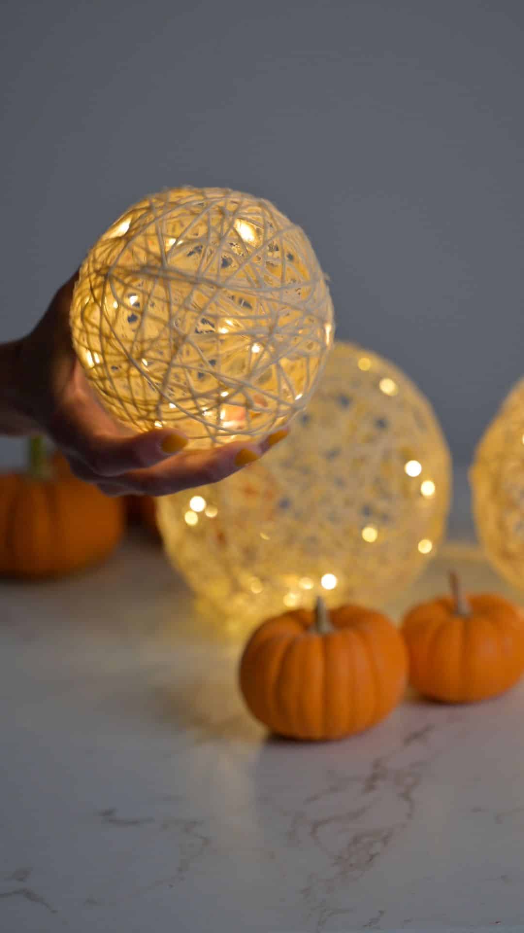 three glowing yarn craft DIY fairy lanterns.