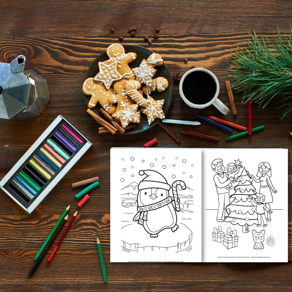 A wooden table with an open printable Christmas coloring book and some colored pencils, Christmas cookies and a mug of coffee.