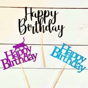 Three glitter cardstock cake toppers made from a cricut.